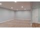 Open finished basement area featuring carpet, hardwood floors, recessed lighting, and neutral paint at 1035 Quartz St, Golden, CO 80401