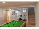 Finished basement with an entertainment area, exercise equipment, and a sliding barn door at 1035 Quartz St, Golden, CO 80401