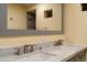 Bathroom featuring double sink with marble countertop and a large mirror that showcases a tiled shower at 1035 Quartz St, Golden, CO 80401
