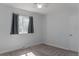 Empty bedroom with neutral carpet, a window with dark curtains and fresh white paint at 1035 Quartz St, Golden, CO 80401