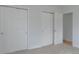 Spacious bedroom with neutral carpet and multiple closets, offering ample storage space at 1035 Quartz St, Golden, CO 80401