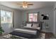 Cozy bedroom featuring two windows for natural light, stylish decor, and a comfortable bed at 1035 Quartz St, Golden, CO 80401