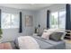 Stylish bedroom featuring two large windows, modern decor, and a comfortable bed with decorative pillows at 1035 Quartz St, Golden, CO 80401