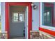 Inviting red trimmed doorway with stone accents and contemporary lighting at 1035 Quartz St, Golden, CO 80401