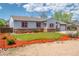 Charming single story home with stone accents, tidy landscaping, and vibrant mulch beds at 1035 Quartz St, Golden, CO 80401