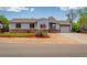 Single story home features stone accents, a well-maintained lawn, and fresh landscaping at 1035 Quartz St, Golden, CO 80401