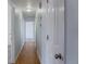 Hallway with hardwood floors and white doors leading to various rooms at 1035 Quartz St, Golden, CO 80401