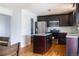 Modern kitchen featuring stainless steel appliances and dark wood cabinets and an island at 1035 Quartz St, Golden, CO 80401