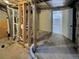 Unfinished basement transitioning to a finished room with white door and window at 16425 E 17Th Pl # A, Aurora, CO 80011