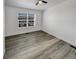 This bedroom features a ceiling fan, large window, and modern gray flooring at 16425 E 17Th Pl # A, Aurora, CO 80011