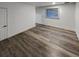 This bedroom has wood floors, white walls, a window with blinds, and a white door at 16425 E 17Th Pl # A, Aurora, CO 80011