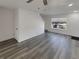 Open living room featuring modern gray flooring, white walls, and a bright window at 16425 E 17Th Pl # A, Aurora, CO 80011