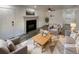 Bright living room with a black fireplace, gray accent chairs, and a patterned rug at 16425 E 17Th Pl # A, Aurora, CO 80011