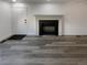 Cozy living room showcasing a classic fireplace with black tile and gray flooring at 16425 E 17Th Pl # A, Aurora, CO 80011