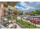 Balcony with seating overlooks complex with landscaping, parking and other apartment buildings at 9019 E Panorama Cir # D207, Englewood, CO 80112