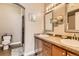 Bathroom with double sinks, decorative mirrors, and tiled shower at 9019 E Panorama Cir # D207, Englewood, CO 80112