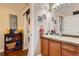 Bathroom featuring a vanity with tile countertop, decorative mirror, and a stackable washer and dryer at 9019 E Panorama Cir # D207, Englewood, CO 80112