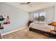 Bedroom features a ceiling fan and a large window, with neutral-colored carpet and walls at 9019 E Panorama Cir # D207, Englewood, CO 80112