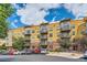 Apartment building with balconies, parking, and professional landscaping at 9019 E Panorama Cir # D207, Englewood, CO 80112