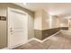 Hallway view showing carpet, two-tone walls and a door with unit number at 9019 E Panorama Cir # D207, Englewood, CO 80112