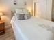 Inviting bedroom featuring a queen bed with decorative pillows and light wood-look flooring at 9390 W Chatfield Pl # 103, Littleton, CO 80128