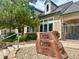 Community clubhouse at Deer Creek featuring lush landscaping and welcoming signage at 9390 W Chatfield Pl # 103, Littleton, CO 80128