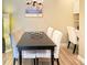 Dining area with seating for four, a built-in desk area, and modern lighting at 9390 W Chatfield Pl # 103, Littleton, CO 80128