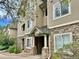 Inviting condo exterior featuring stone accents, neutral siding, and well-maintained landscaping at 9390 W Chatfield Pl # 103, Littleton, CO 80128