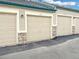 Detached garages with stone accents and individual unit numbers offer convenient parking solutions at 9390 W Chatfield Pl # 103, Littleton, CO 80128