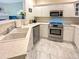 Bright kitchen with white cabinets, stainless steel appliances, and modern countertops at 9390 W Chatfield Pl # 103, Littleton, CO 80128