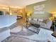 Spacious living room area with a large couch, a coffee table, and an open dining area at 9390 W Chatfield Pl # 103, Littleton, CO 80128