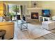 Comfortable living room with a fireplace and a sliding glass door leading to the patio at 9390 W Chatfield Pl # 103, Littleton, CO 80128
