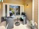Cozy patio seating area with glass table, grill, and sliding glass doors for indoor-outdoor living at 9390 W Chatfield Pl # 103, Littleton, CO 80128