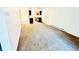 Open-concept living area with kitchenette and neutral carpeting at 14720 E Kentucky Dr # 611, Aurora, CO 80012