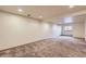 Finished basement space with neutral paint and carpet throughout, and recessed lights at 7580 S Monaco Way, Centennial, CO 80112