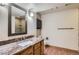 Finished bathroom with granite countertops, modern vanity, updated fixtures and wood style floors at 7580 S Monaco Way, Centennial, CO 80112