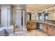 Large bathroom features dual sinks with granite countertops, a glass shower, and neutral tile floors at 7580 S Monaco Way, Centennial, CO 80112