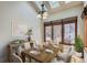 Bright dining room with large windows, hardwood floors, and stylish furnishings at 7580 S Monaco Way, Centennial, CO 80112