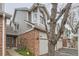 Charming townhome featuring a brick facade, attached garage, and manicured landscaping at 7580 S Monaco Way, Centennial, CO 80112