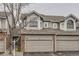 Exterior showcases light gray siding, brick accents, and an attached two-car garage at 7580 S Monaco Way, Centennial, CO 80112