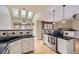 Kitchen with granite countertops, stainless appliances, white cabinetry and tiled backsplash at 7580 S Monaco Way, Centennial, CO 80112