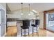 Kitchen with bar seating, hardwood floors, stainless appliances and access to the outdoor deck at 7580 S Monaco Way, Centennial, CO 80112