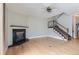 Spacious living room with hardwood floors, fireplace, and staircase at 7580 S Monaco Way, Centennial, CO 80112