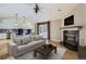 Open-concept living room featuring a fireplace, hardwood floors, sofa, and a table at 7580 S Monaco Way, Centennial, CO 80112