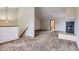 Living room includes fireplace, stairs, and doorway to another room at 7580 S Monaco Way, Centennial, CO 80112