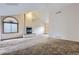 Spacious living room with large window, vaulted ceiling, and fireplace at 7580 S Monaco Way, Centennial, CO 80112