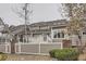 View of the rear of the home with a patio and a wooden fence at 7580 S Monaco Way, Centennial, CO 80112
