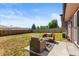 Spacious backyard featuring a patio seating area, perfect for outdoor relaxation and gatherings at 13542 Achilles Dr, Lone Tree, CO 80124