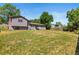 Large, private backyard with mature trees, ample space, and a patio area at 13542 Achilles Dr, Lone Tree, CO 80124