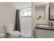 A well-lit bathroom with a shower, stylish sink, and neutral color scheme at 13542 Achilles Dr, Lone Tree, CO 80124